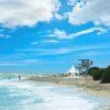 The photograph is of a typical picturesque Florida beach scene. It features a shoreline with gentle