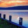 This colorful photograph shows the serene waterfront scene at Acabonic Harbor during a vibrant