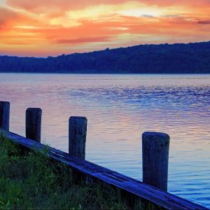 This colorful photograph shows the serene waterfront scene at Acabonic Harbor during a vibrant