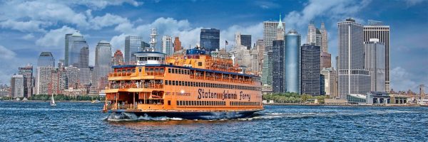 This is a photo of NY Harbor and lower Manhattan. The Staten Island Ferry dominates the foreground