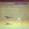 This photograph captures a serene image of a swan gracefully gliding over Red Creek Pond. Its wings