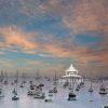 This a photograph showcasing the serene view of numerous sailboats and yachts peacefully moored in