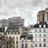 The foundation scaffolding for the new spire of Notre Dame rises over the medieval houses