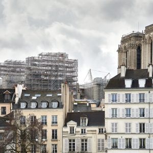 The foundation scaffolding for the new spire of Notre Dame rises over the medieval houses