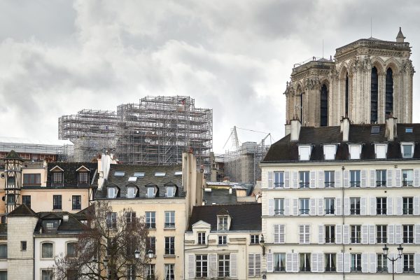 The foundation scaffolding for the new spire of Notre Dame rises over the medieval houses