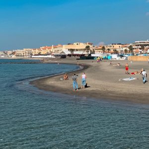 The photograph captures the sweeping expanse of Lido di Ostia, Rome’s beloved seaside retreat, where