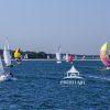 Racing fleet under spinnaker truckin' towards Greenport on a broad reach.
