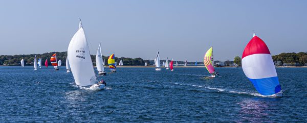 Racing fleet under spinnaker truckin' towards Greenport on a broad reach.