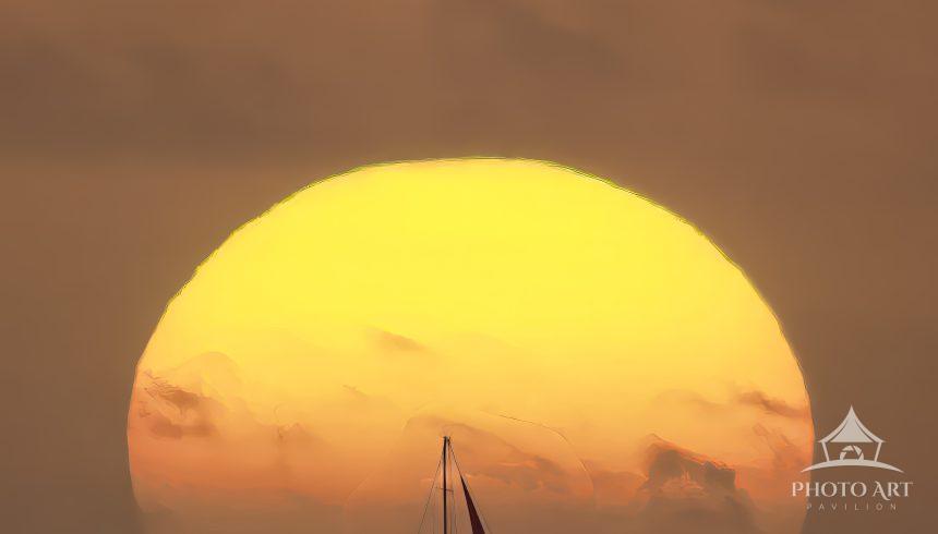 The yellow ball of the sun rises over the Atlantic ocean in "Voyage on Sunlit Seas".