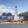 The New London Harbor Light surrounded by private residences.