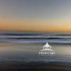 The artwork is a serene seascape featuring soft, gentle waves blending seamlessly into a hazy