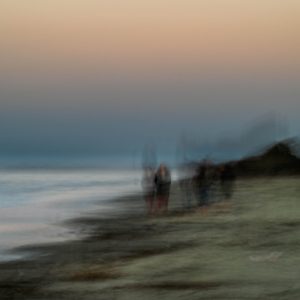Day's end. Last rays of sunlight as the sun sets below the horizon. A quiet walk along the beach