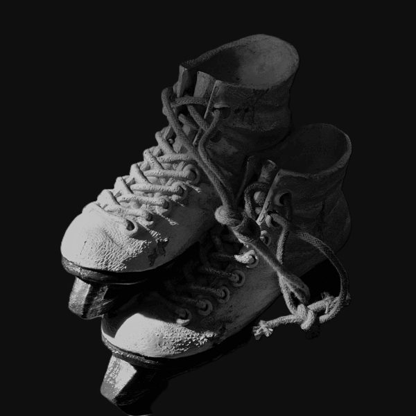 Skates with worn and creased leather catching vivid directional light. Frayed laces hint of