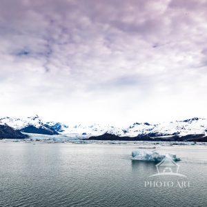 “Drift Alone” captures the quiet poetry of a single iceberg floating through a vast, glacial