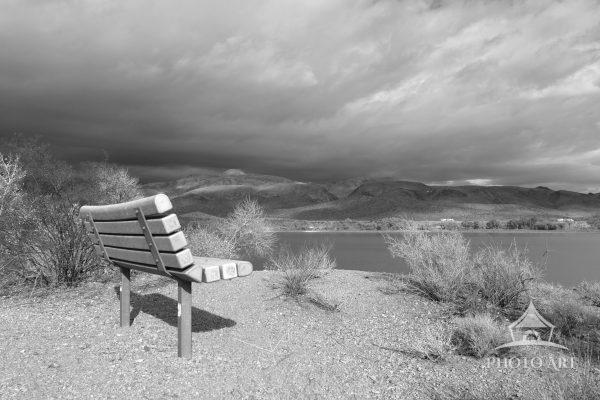 A bench on the west side of Upper Pahranagat Lake looks toward the stormy skies to the east.