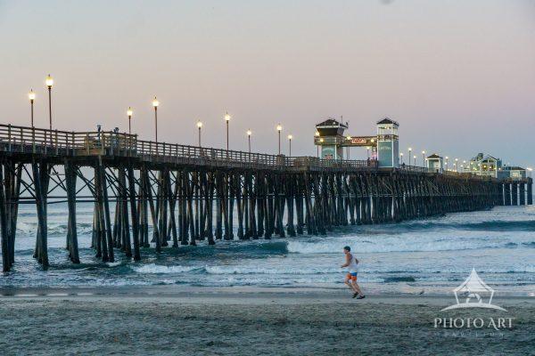 Jogger during a sunrise morning at Oceanside Pier