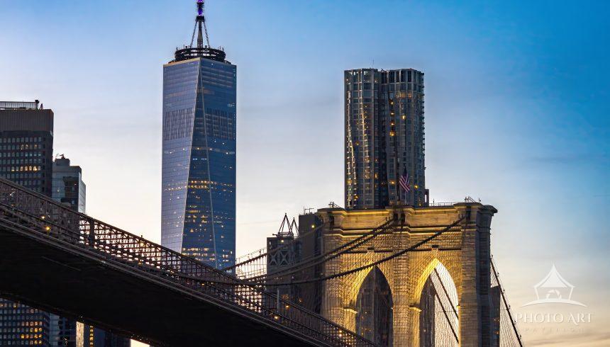A breathtaking sunset view of the Brooklyn Bridge as warm golden light fades into rich twilight