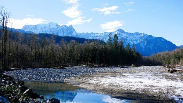 A dry riverbed framed by the Cascade Foothills