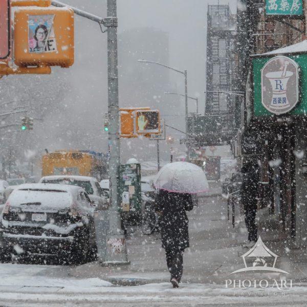 Snow softens the city, yet its color and character persist. An iconic New York City street moment,