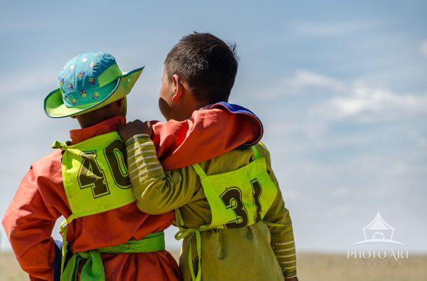 Two young riders/competitors in a horse race in the Gobi Desert, Mongolia