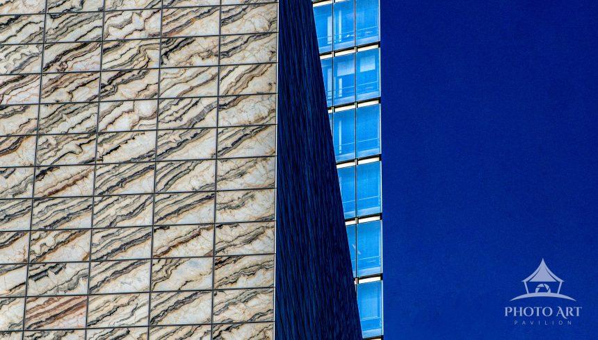 A striking contrast of textures defines this façade from Lower Manhattan—where rigid grid patterns