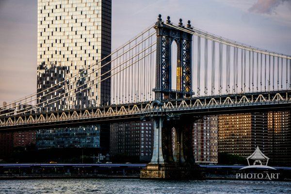Framed against the textured skyline of New York City, the Manhattan Bridge unfolds as a study in