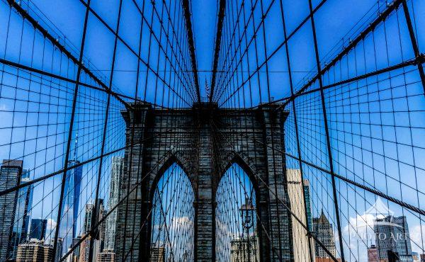 The sweeping cables of the Brooklyn Bridge form a powerful web of intersecting lines, converging