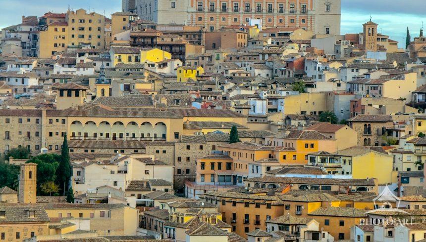 Majestic Alcázar fortress dominates Toledo's historic skyline, overlooking a dense tapestry of
