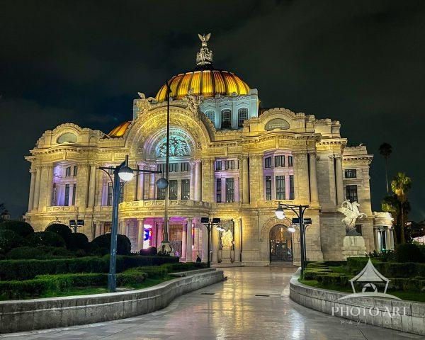 Illuminated Palacio de Bellas Artes in Mexico City at night, showcasing its ornate facade, golden