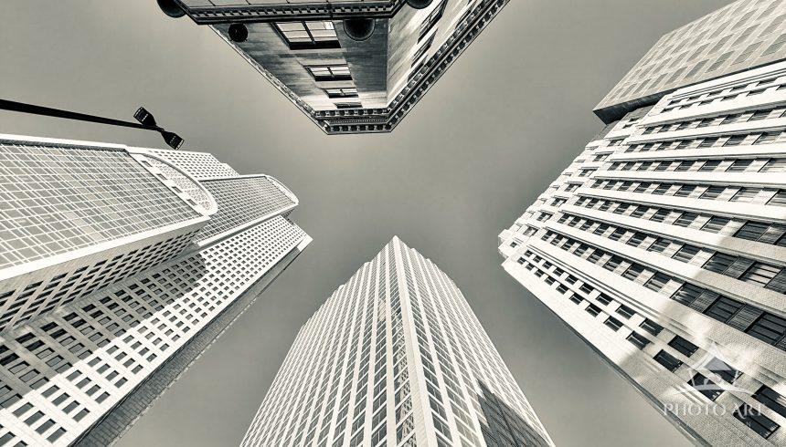 Dramatic black-and-white view of towering skyscrapers in a dense urban business district,