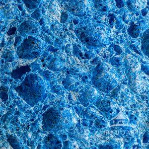 A fascinating look at the textured landscape of a common kitchen sponge.