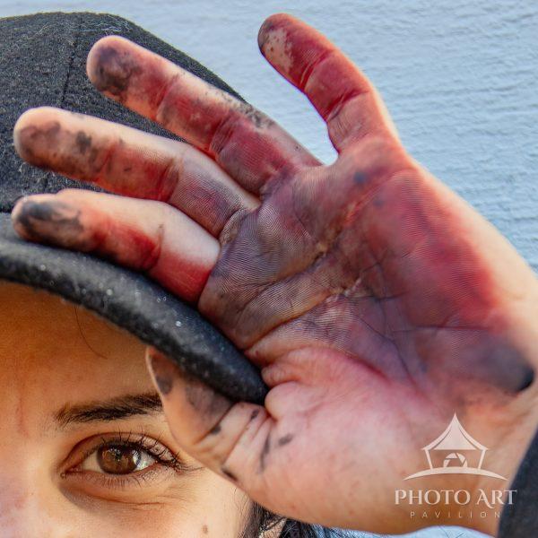 Tight crop of a portrait of a muralist showing their essential tools: eye, mind, and hand.