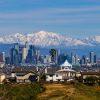Stunning view of Los Angeles skyline with snow capped San Gabriel mountains.