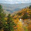The scene captures the beauty and grandeur of autumn in the mountains at its seasonal peak