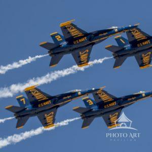 Four of the US Navy Blue Angel planes take flight over the skies of Jones Beach on Long Island, NY