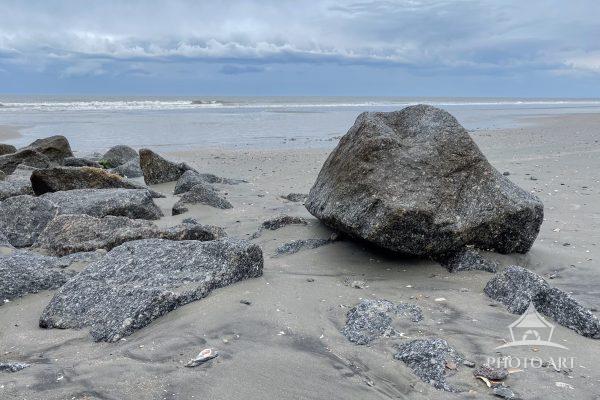 Low tide reveals large rocks on the beach