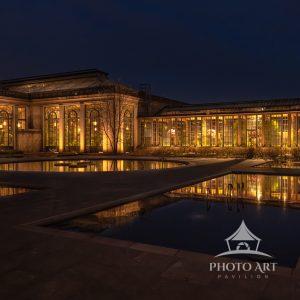Longwood Gardens Conservatory at night with the Lily ponds in the forground.