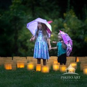 Brother and sister holding hands and enjoying the evening at Longwood gardens.