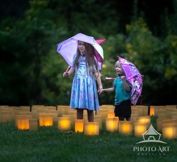 Brother and sister holding hands and enjoying the evening at Longwood gardens.