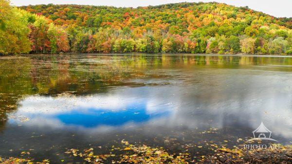 This expansive horizontal landscape photograph showcases the breathtaking autumn beauty of Scarlet